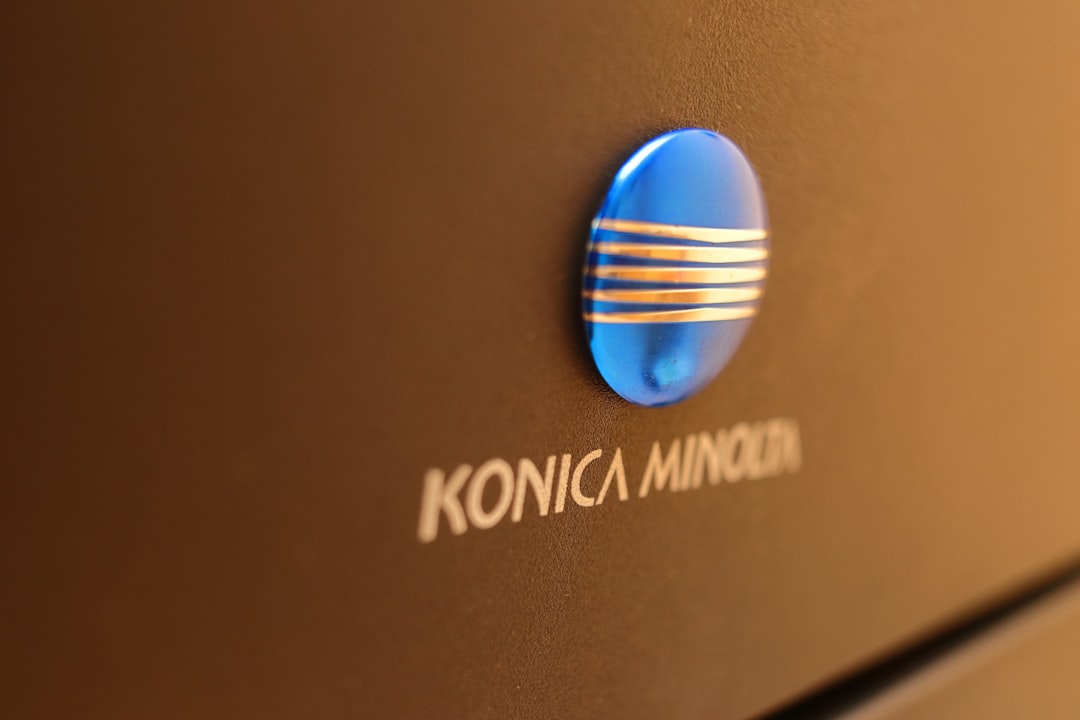 Konica minolta logo on a dark surface
